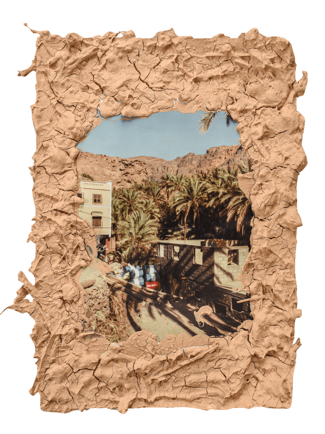 Image framed by soil, showing buildings in an Moroccon oasis.