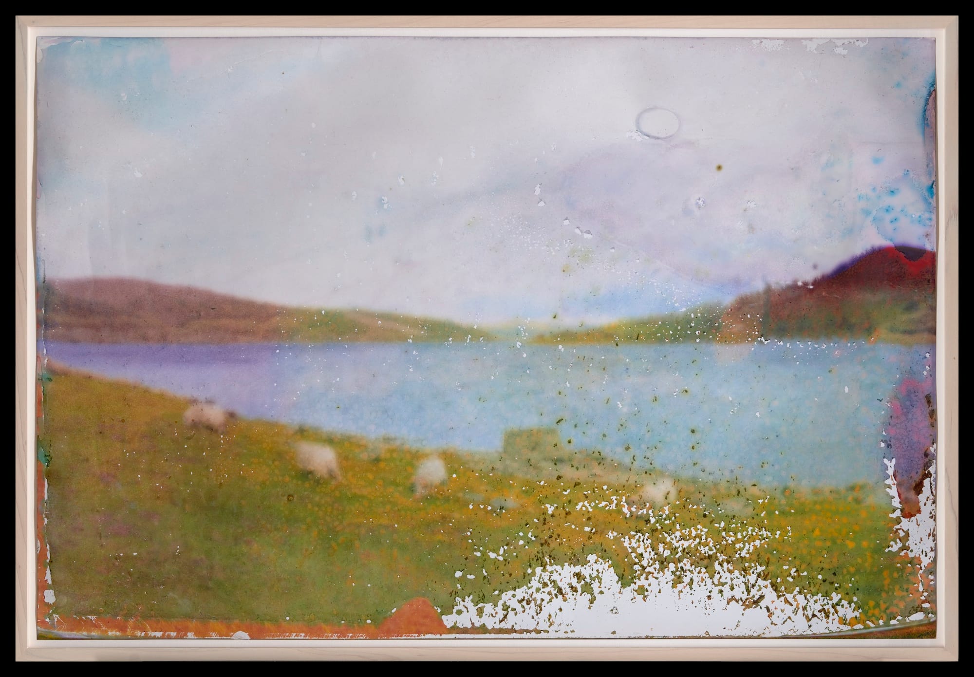 A landscape depicting lake and mountains. (The print is blurred on purpose.)