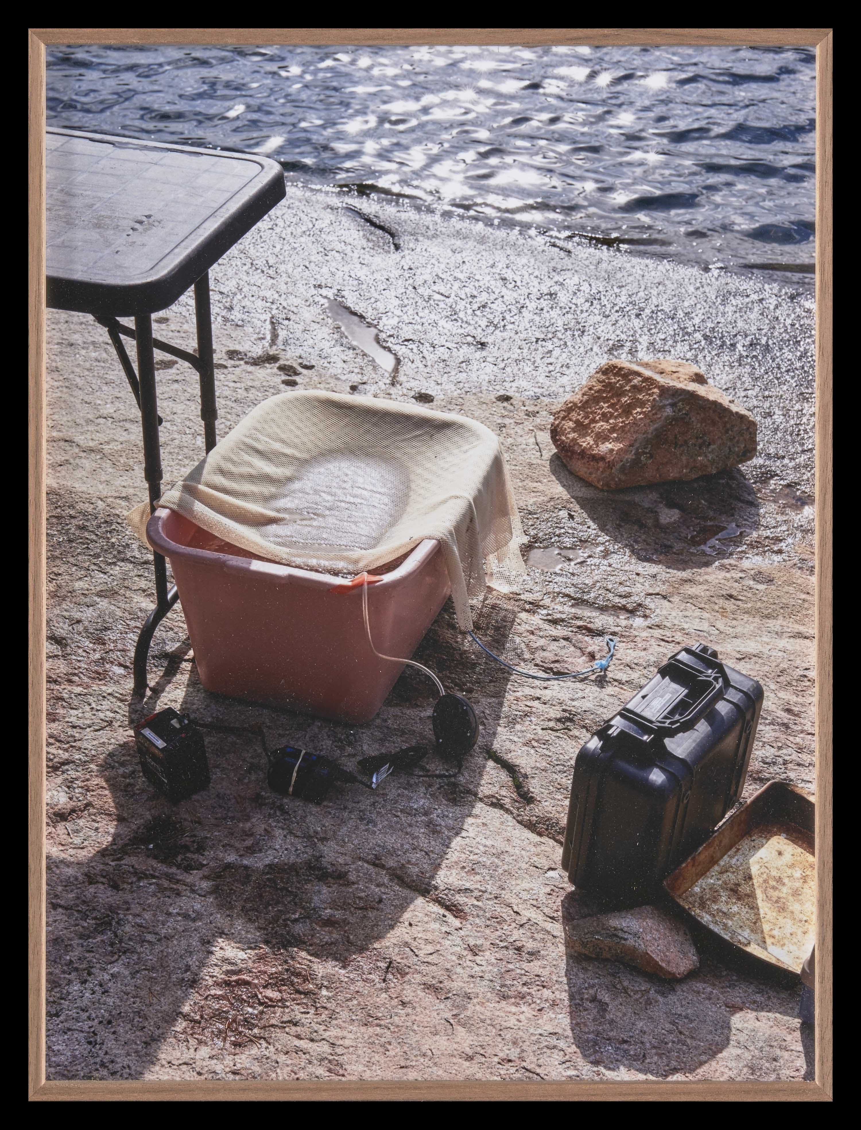 A selection of research equipment standing next the water.