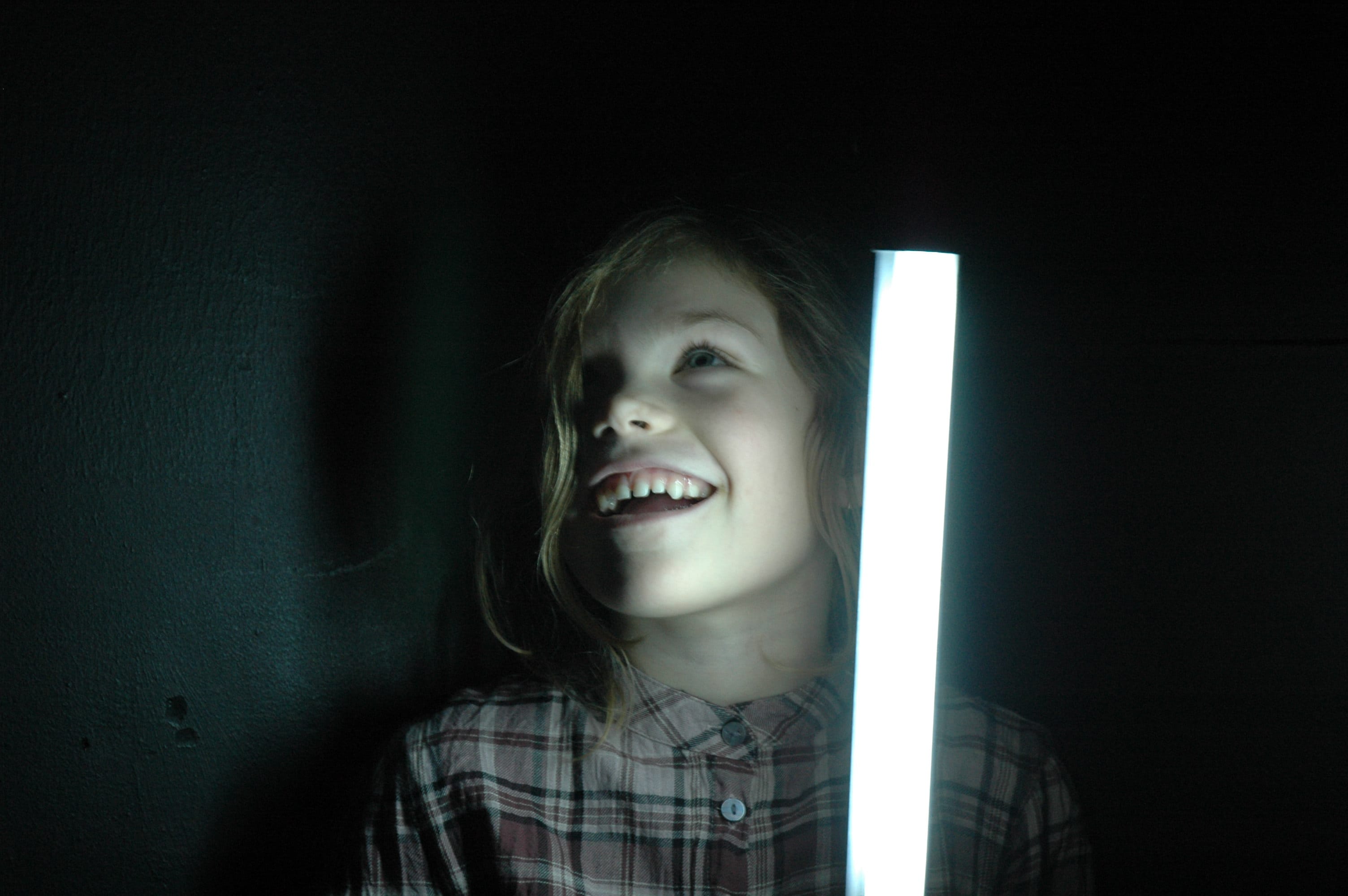 Portrait of a young girl holding a lamp